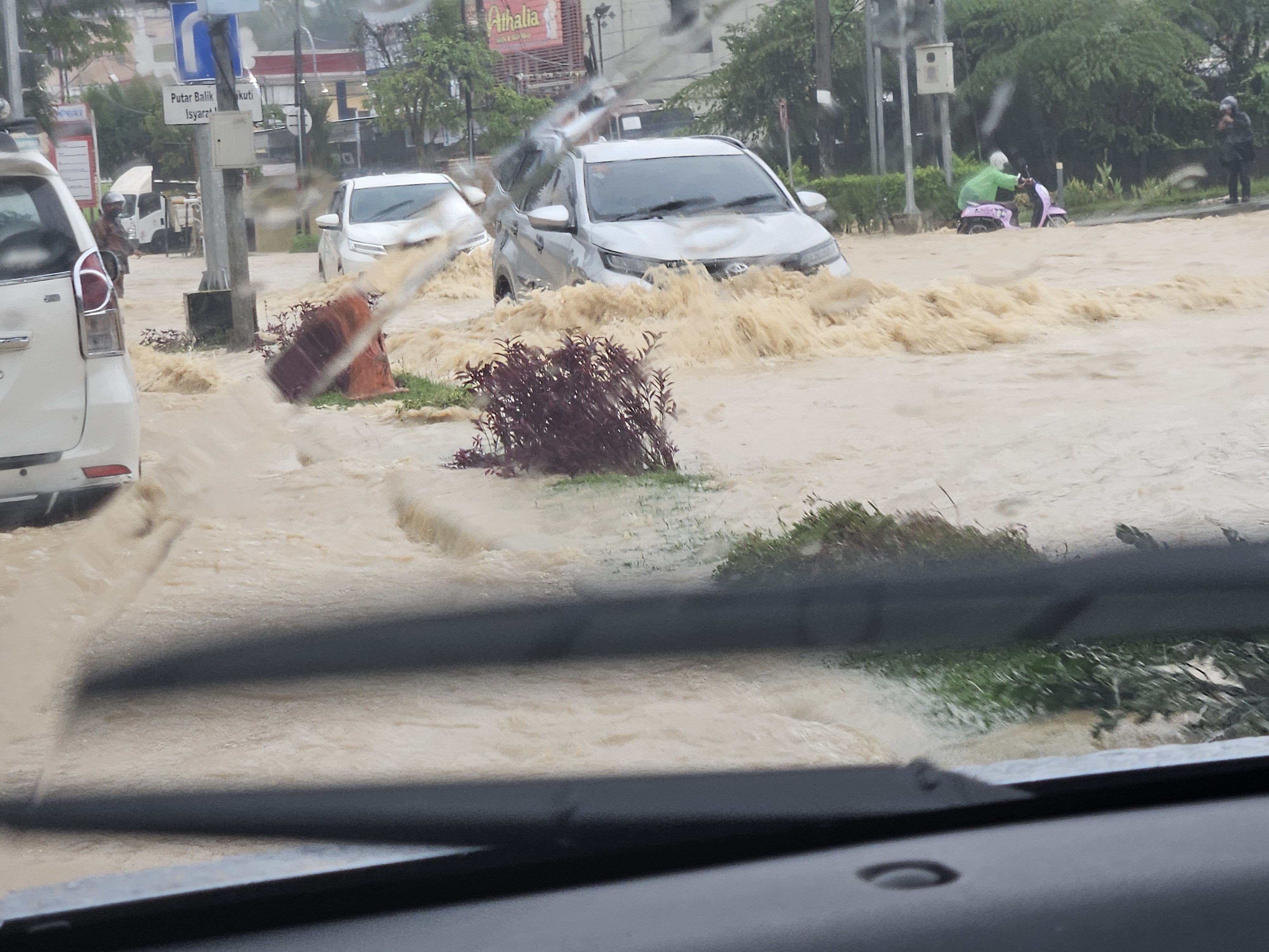 Heavy rain on mining road in Indonesia causing difficult driving conditions