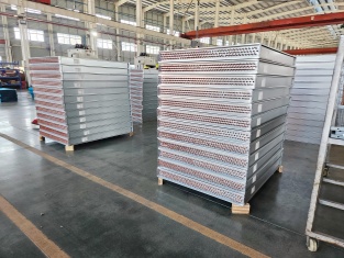 Industrial finned tube heat exchanger panels prepared for assembly
