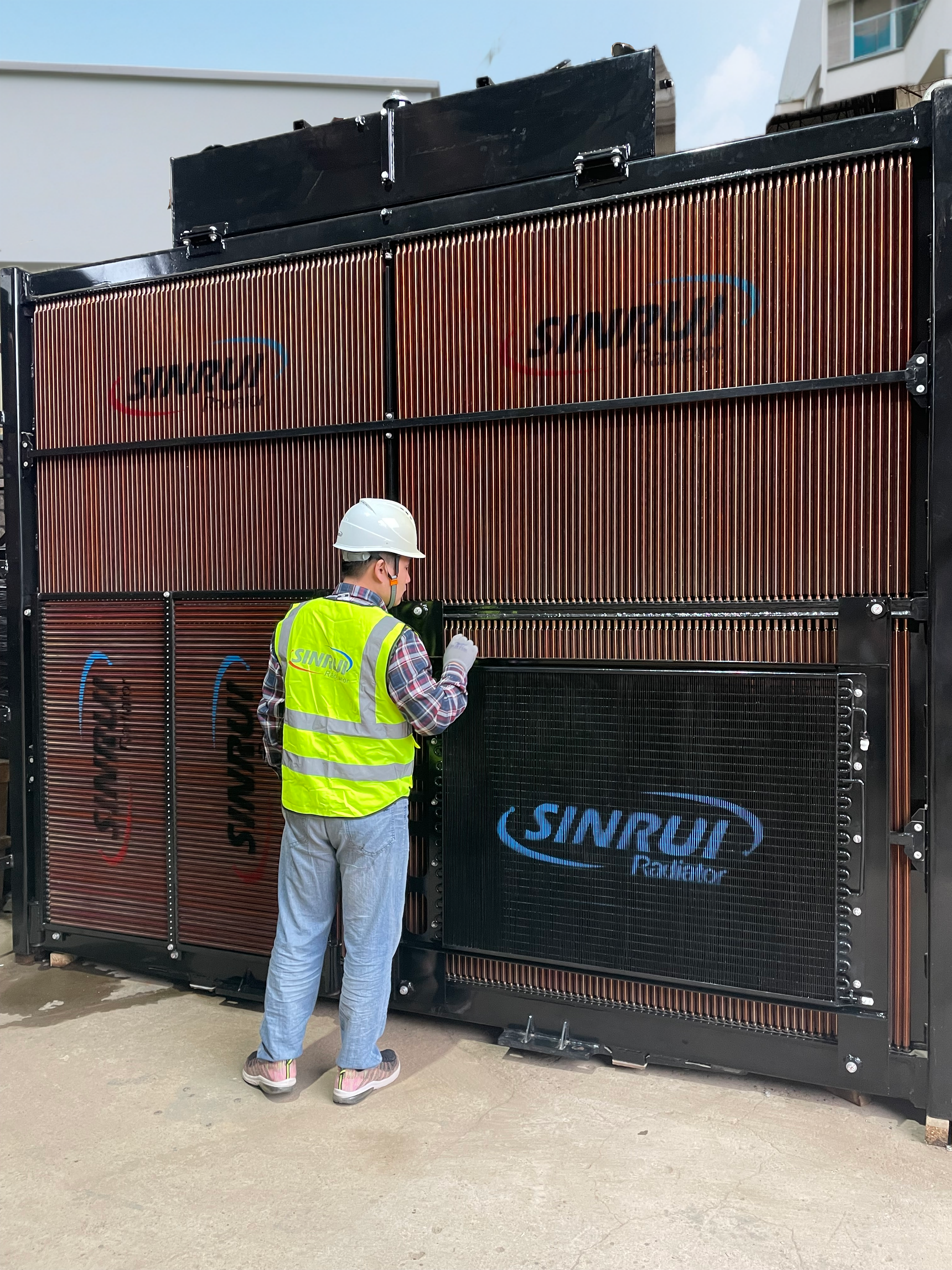 SINRUI technician inspecting customized mining radiator before delivery